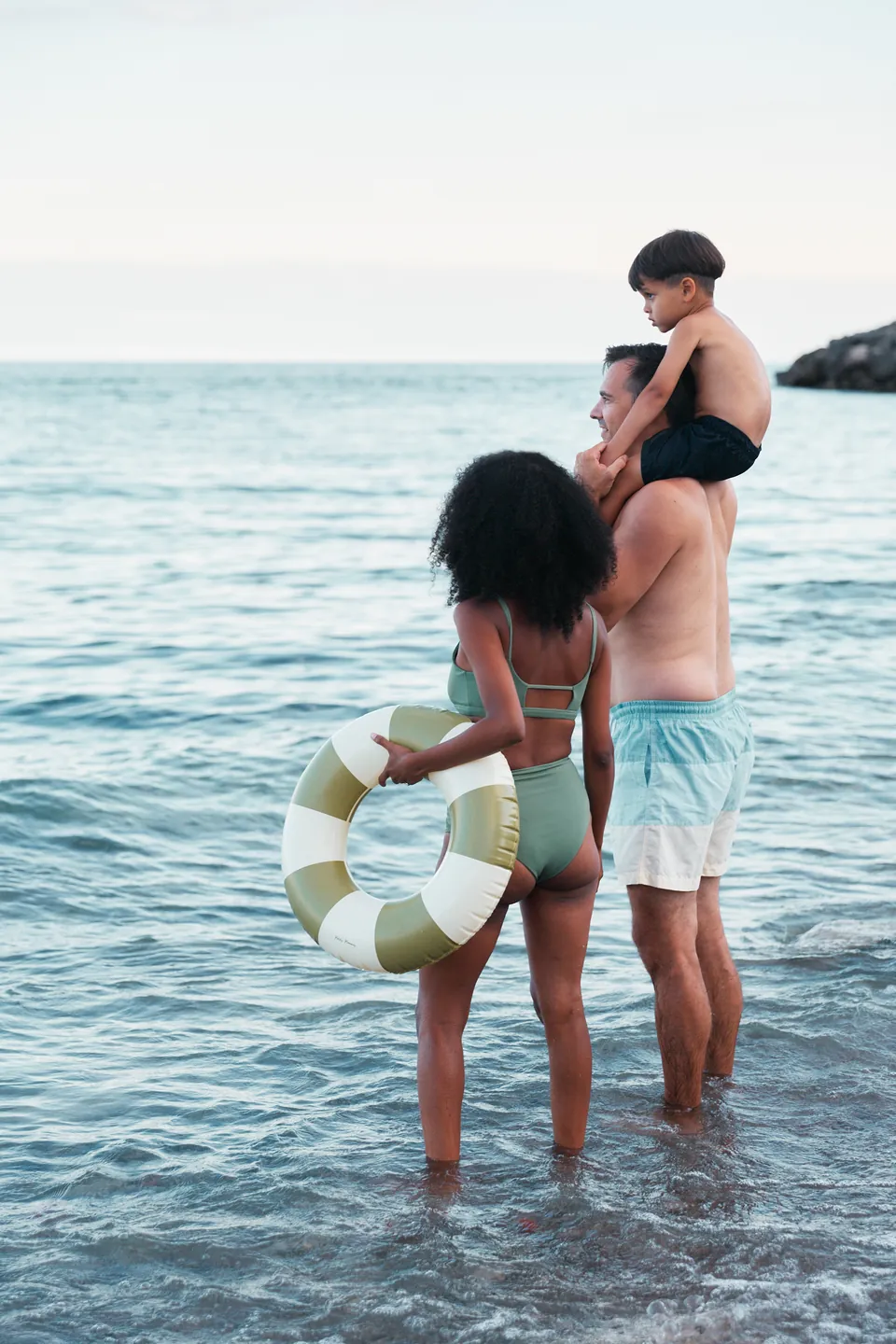A family wading in the shallows of Lake Ontario