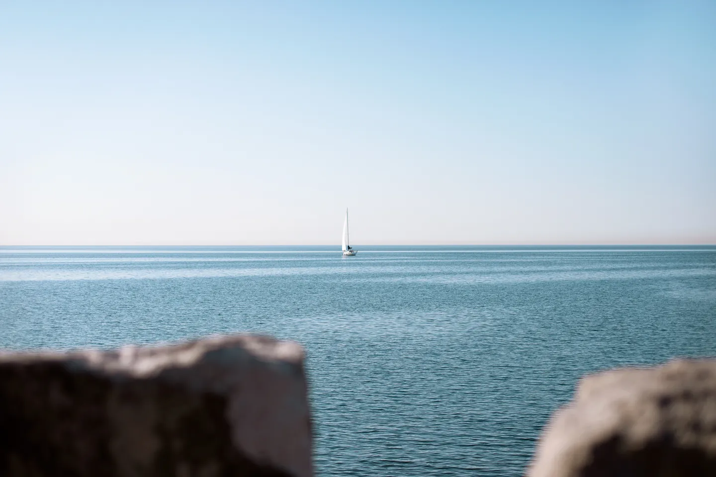 A sailboat on Lake Ontario seen from the shore